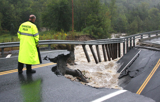 Bennington Police Chief Paul Doucette looks at a collapsed bridge on Route 9 in Woodford, Vt on Sunday, Aug 28, 2011. The remnants of Hurricane Irene dumped torrential rains on Vermont on Sunday, flooding rivers and closing roads from Massachusetts to the Canadian border, putting parts of two towns underwater and leaving one young woman swept away and feared drowned in the Deerfield River. (AP)