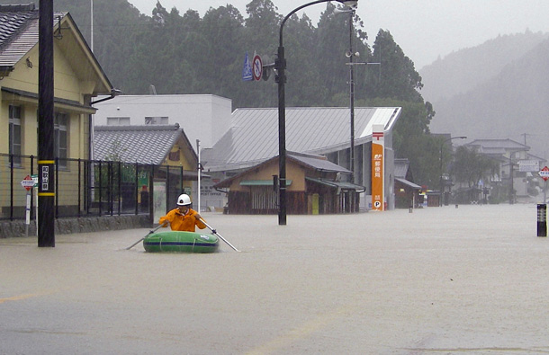 A local rescuer rows a rubber boat on floodwaters brought about by Typhoon Talas in Tanabe city, Wakayama prefecture, central Japan. Because of the slow moving, the Japan Meteorological Agency warned of heavy rain and strong winds centered in south-central Japan that could lead to flooding and landslides. (AP)