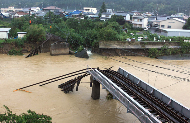 An iron bridge over the Nachi River is seen damaged by Typhoon Talas in Nachikatsuura town, Wakayama prefecture, central Japan. The powerful typhoon traversed the southern Japanese island of Shikoku and the central part of the main island of Honshu overnight, leaving a trail of heavy rainfall and mudslides in some areas of the country. (AP)