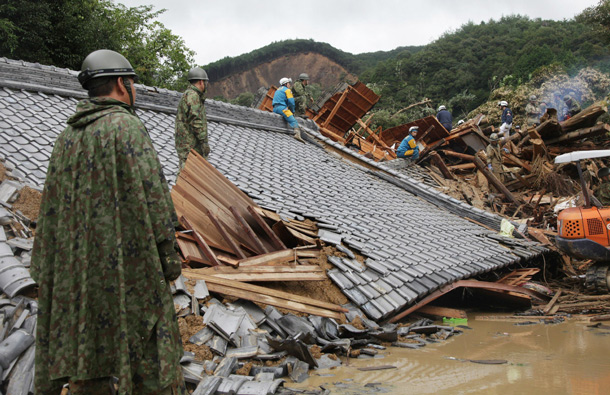 Rescue workers and Japan Self-Defence Force soldiers search for missing people amongst a destroyed house caused by floodwaters in Tanabe, Wakayama prefecture, in western Japan. Typhoon Talas cut across western Japan late on September 3, leaving at least 17 people dead and 43 missing after heavy rains and fierce winds. (AFP)