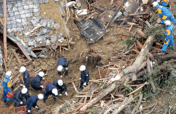 Japanese soldiers and police officers search destroyed houses for missing people after a landslide triggered by Typhoon Talas that brought heavy rains at Tanabe, central Japan. The storm dumped record amounts of rain Sunday in western and central Japan as it turned towns into lakes, washed away cars and triggered mudslides that obliterated houses. (AP)