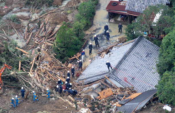 Rescuers search destroyed houses for missing people after a landslide triggered by Typhoon Talas that brought heavy rains at Tanabe, central Japan. The storm dumped record amounts of rain Sunday in western and central Japan as it turned towns into lakes, washed away cars and triggered mudslides that obliterated houses. (AP)