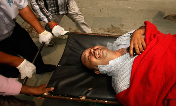 A person injured in a bomb explosion reacts in pain as he is brought to the RML hospital in New Delhi, India, Wednesday, Sept 7, 2011. The bomb apparently hidden in a suitcase exploded outside a crowded gate leading to the High Court in New Delhi, killing nine people and wounding 45 others, officials said. (AP)