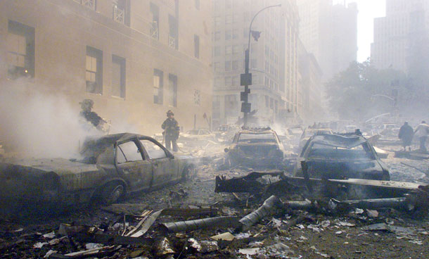 Cars smolder in the street as the destroyed World Trade Center burns in New York in this September 11, 2001 file photo. September 11th marks the 10th anniversary of the 9/11 attacks where nearly 3,000 people died when four hijacked airliners were used in coordinated strikes on the Pentagon and the World Trade Center towers. The fourth plane crashed in Pennsylvania. (REUTERS)