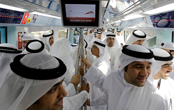 Emirati officials ride inside a train during the opening of Metro Green Line which stretches 23 km and comprises 18 stations in Dubai, United Arab Emirates, Friday Sept. 9, 2011. (AP)