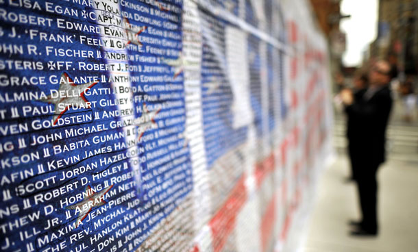 A visitor reads the names and of 9/11 terrorist attack victims on a wall outside Ground Zero memorial  in Manhattan on September 10, 2011. New York marks the 10th anniversary of the 9/11 terrorist attacks on Sunday. (AFP)