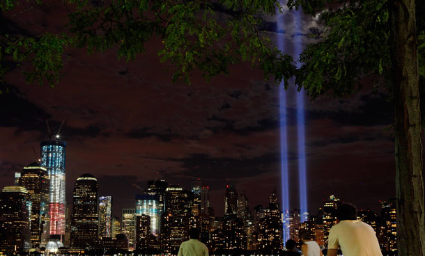 The "Tribute in Lights" (R) and One World Trade Center (L - lit in red, white and blue) illuminate the lower Manhattan skyline as seen from Jersey City, New Jersey September 10, 2011.  National and city leaders will commemorate on Sunday the ten-year anniversary of the 9/11 attacks with a ceremony unveiling a memorial and museum. (REUTERS)