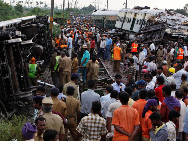 Rescue workers and others crowd next to the compartments of two trains after they collided near Arakkonam, southwest of Chennai, India, Wednesday, Sept. 14, 2011. The passenger train traveling through southern India collided with another train stopped at a signal on Tuesday, killing eight people and injuring dozens more, a government official said. (AP)