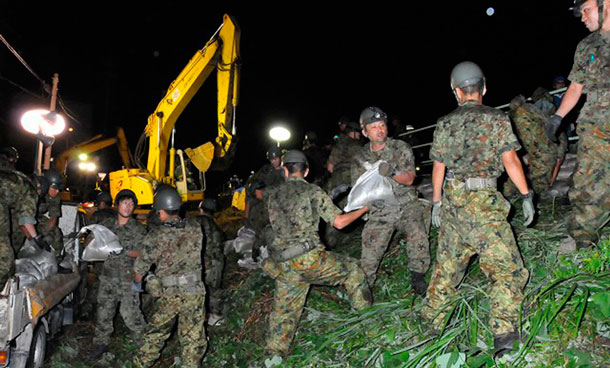 Japan Ground Self-Defence Force soldiers pass sandbags to reinforce embankments on Hatta river to prevent further damage due to typhoon Roke in Kasugai, central Japan in this handout photo taken on early September 21, 2011. At least four people died and two were missing in Japan as typhoon Roke bore down on Tokyo on Wednesday, bringing heavy rain and strong winds. (REUTERS)