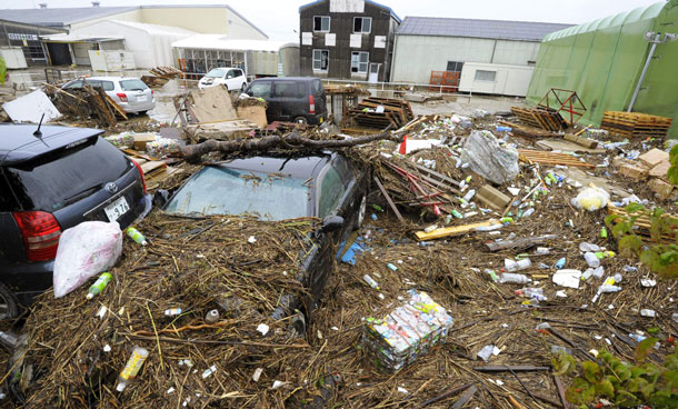 A parking lot is covered with trash from a flooded river due to heavy rain in Nagoya, central Japan Wednesday, Sept 21, 2011. Heavy rains as a powerful typhoon approached caused floods and road damage in dozens of locations in Nagoya and several other cities, the Aichi prefectural (state) government said. (AP)