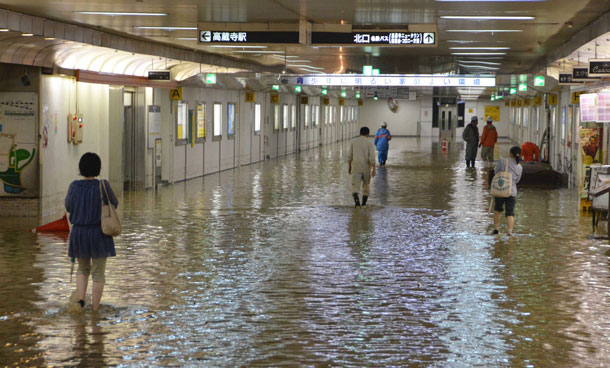 People wade through a flooded underpass of a railway station in Kasugai, central Japan Tuesday, Sept 20, 2011. More than a million people in central Japan were urged to evacuate Tuesday as a powerful typhoon approached, triggering floods. (AP)