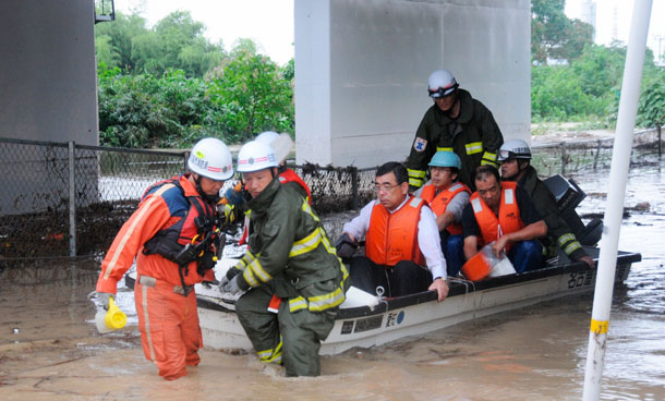 Residents are rescued from a flooded area in Nagoya, central Japan, in this photo taken by KyodoSeptember 20, 2011. More than a million people in the central Japan city of Nagoya were advised to evacuate on Tuesday as typhoon Roke approached the country, bringing heavy rain. (REUTERS)