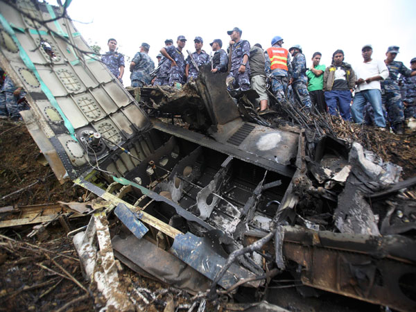 Nepalese police personnel are seen at the crash site of Buddha Air plane in Lalitpur September 25, 2011. The small plane carrying foreign tourists to view Mount Everest crashed in bad weather near Nepal's capital Kathmandu on Sunday, killing all 19 people on board, officials said.   (REUTERS)