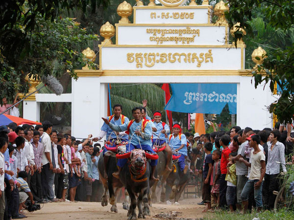 Men ride buffaloes during an annual buffalo-racing ceremony at Virhear Sour village in Kandal province, 30 km (18 miles) southeast of Phnom Penh September 27, 2011. The ceremony, which started more than 70 years ago, is held to honour the Neakta Preah Srok pagoda spirit. (REUTERS)