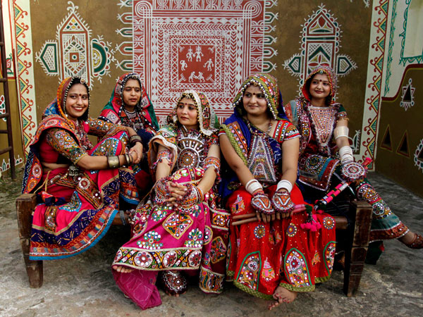 Indian girls wearing traditional attire watch others practice the Garba, a traditional folk dance of western Indian state of Gujarat, as part of preparation for Navratri festival in Ahmadabad, India, Friday, Sept. 23, 2011. (AP)