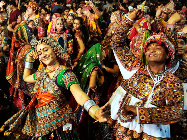 Indians in traditional attire take part in Garba, a traditional dance of western Indian state of Gujarat on the first night of nine nights festival "Navratri" in Ahmadabad, India, Wednesday, Sept. 28, 2011. (AP)