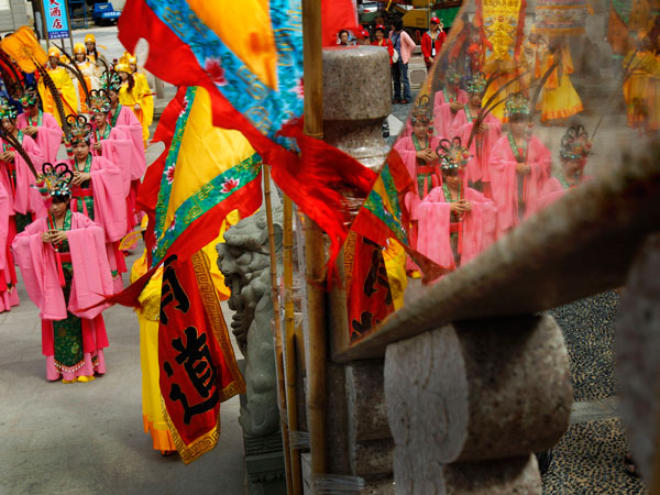 Dancers, seen in a reflection, prepare for a celebration of Matsu, the Chinese goddess of the sea on Nangan Island in Taiwan's outlying Matsu Island chain, Wednesday, Oct. 5, 2011. (AP)