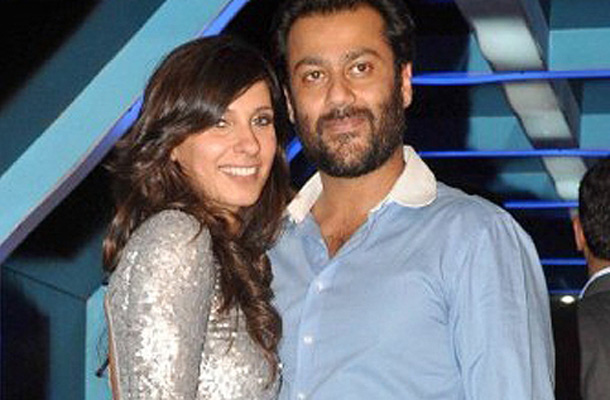 Abhishek Kapoor (R) with model Ramola pose for a photo at the launch of the Planet Volkswagen cars party. (AFP)