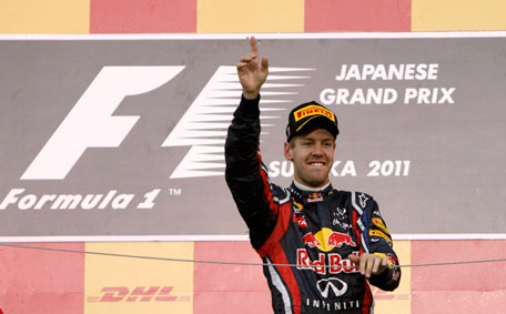 Red Bull Formula One driver Sebastian Vettel of Germany celebrates winning the world championship after finishing third in the Japanese F1 Grand Prix at the Suzuka circuit on Sunday. (REUTERS)
