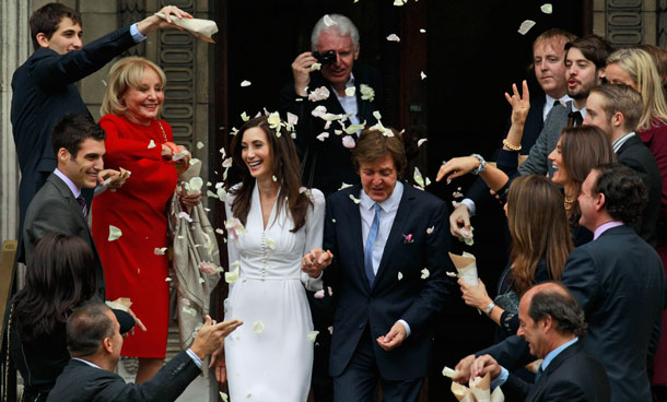 Former Beatle Paul McCartney and American heiress Nancy Shevell exit Marylebone Town Hall in central London after they were married  Sunday Oct 9 2011.  Shevell, 51, is McCartney's third wife. They were engaged earlier this year. The couple met in the Hamptons in Long Island, New York, shortly after the singer's divorce from Heather Mills in 2008. (AP)
