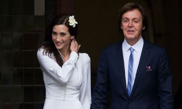Sir Paul McCartney (R) and his new wife Nancy Shevell (L) leave Marylebone registry office in central London following their wedding on October 9, 2011. Beatles legend Paul McCartney and New York heiress Nancy Shevell arrived for their wedding in a town hall in london on Sunday, waving to hundreds of fans. (AFP)