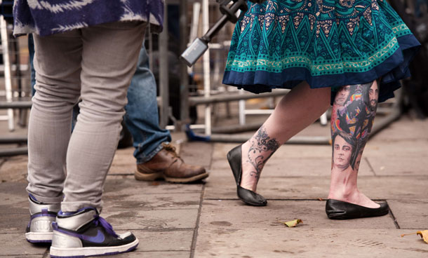 A Beatles fan shows her tattoos to the media as she waits outside Marylebone registry office in central London on October 9, 2011.  With this marriage being Sir Paul's third, Marylebone registry office has been rumoured to be the location as this was where he married his first wife, Linda. (AFP)