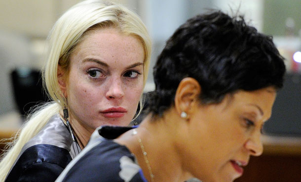 Lindsay Lohan, left, is pictured alongside her attorney Shawn Chapman Holley during a case review conference in Los Angeles. A city prosecutor on Wednesday, Oct 18, 2011 will ask a judge at a hearing to find Lindsay Lohan in violation of her probation and order her to spend time in jail. The move is based on the actress' most recent probation report that states she was terminated from a women's shelter where a judge wanted her to serve most of her community service.  (AP)