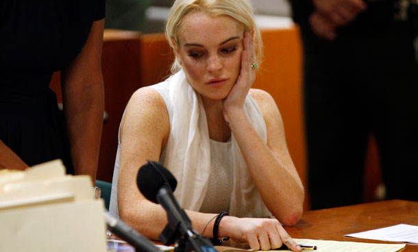 Lindsay Lohan, right, alongside her attorney Shawn Chapman Holley, attends to her probation hearing Wednesday, Oct 19, 2011, in Los Angeles. Superior Court Judge Stephanie Sautner revoked Lohan's probation Wednesday after the actress encountered problems during her community service assignment at a women's shelter. (AP)