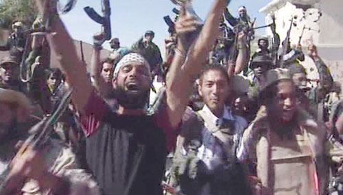 Libyan fighters celebrate in the streets of Sirte (AP)
