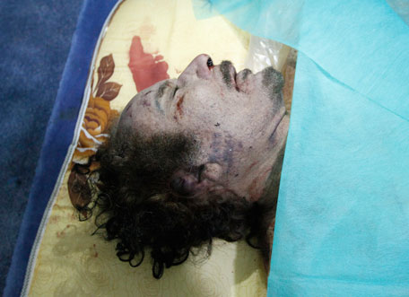 The body of former Libyan leader Muammar Gaddafi is displayed at a house in Misrata October 20, 2011. Muammar Gaddafi was killed by Libyan fighters he once scorned as "rats", cornered, beaten and then shot in the head after his chaotic capture by fighters who overran his last redoubt on Thursday in his hometown of Sirte.   (REUTERS)