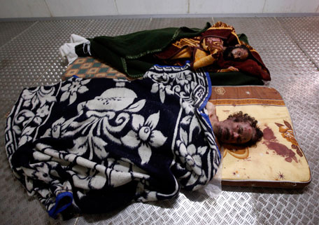 The dead bodies of Muammar Gaddafi (front) and his son Mo'tassim are displayed inside a metal storage freezer in Misrata October 22, 2011. NATO called an end to its air war in Libya, and the clan of Gaddafi demanded a chance to bury the body that lay on display in a meat locker after a death as brutal and chaotic as his 42-year rule. (REUTERS)