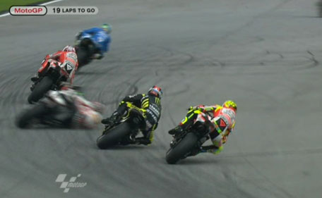 In this image made from video provided by Dorna Sports S.L., Italy's Marco Simoncelli, foreground left, slides across the track as USA's Colin Edwards, center, and Italy's Valentino Rossi, right, round turn 11 during the Malaysian MotoGP Grand Prix in Sepang, Malaysia, Sunday, Oct. 23, 2011. Italian rider Marco Simoncelli died of chest, head and neck injuries Sunday after a crash at the Malaysian MotoGP motorcycle race, organizers said. He was 24. (AP)