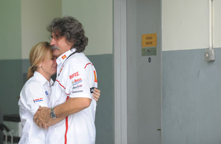 Paolo (R), the father of Marco Simoncelli of Italy, is consoled inside the pit during the Malaysian Grand Prix in Sepang October 23, 2011. Marco Simoncelli has died after a crash at the Malaysian MotoGP in Sepang, organisers said on Sunday. He was 24.   (REUTERS)