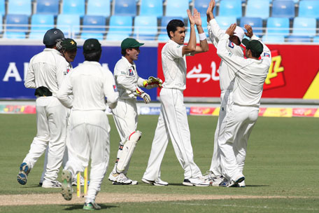 Pakistan's Umar Gul (centre) celebrates the wicket of Sri Lanka's Lahiru Thirimanne on the first day of their second Test in Dubai on Wednesday. (REUTERS)