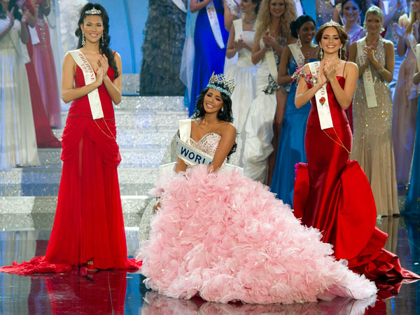 Miss Venezuela, Ivian Sarcos, center, surrounded by Miss Philippines, Gwendoline Ruais, left and Miss Puerto Rico, Amanda Perez, right, reacts after being crowned Miss World 2011 at a central London venue, Sunday, Nov. 6, 2011. (AP)