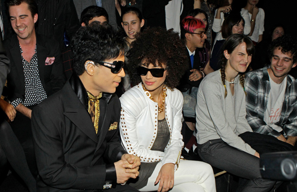 Singer Prince and his date are shown seated before the start of the Versace for H&M fashion show in New York. (AP)