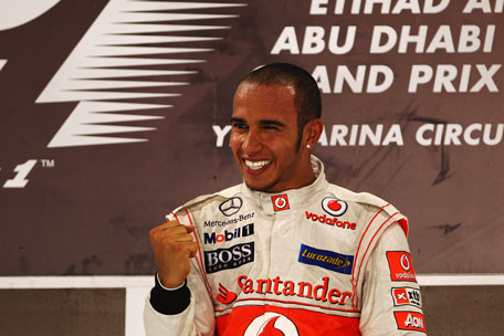Lewis Hamilton of Great Britain and McLaren celebrates on the podium after winning the Abu Dhabi Formula One Grand Prix at the Yas Marina Circuit on Sunday in the UAE. (GETTY)