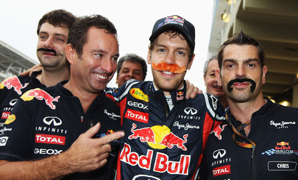 Sebastian Vettel (C) of Germany and Red Bull Racing is seen wearing a false moustache as he celebrates breaking Nigel Mansells record after securing pole position for the fifteenth time this season following qualifying for the Brazilian Formula One Grand Prix at the Autodromo Jose Carlos Pace on November 26, 2011 in Sao Paulo, Brazil. (GETTY)