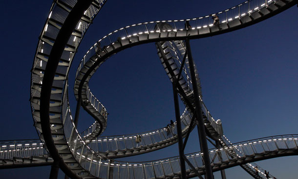 The sculpture 'Tiger and Turtle' is illuminated in Duisburg, Germany. Creators of the two million euro project say 'The roller coaster stands for high speed of a tiger but the visitor has to explore it step by step like a turtle.' 40 visitors at a time can enjoy the views from 85 metres over the Ruhr region via 249 steps but not the loops which are inaccessible. (AP)