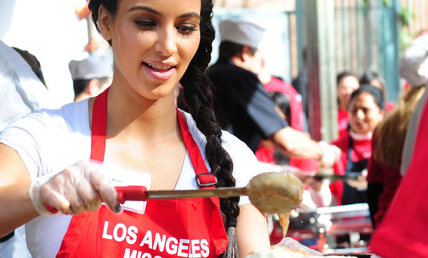 Socialite Kim Kardashian serves as celebrities turn out to feed the homeless and those less fortunate a lunchtime meal at the Los Angeles Mission on Nov 23, 2011 in downtown Los Angeles in celebration of Thanksgiving. The LA Mission has been helping people on skid row for the past 75 years, providing emergency services like shelter, food, clothing as well as professional medical and dental services. (AFP)