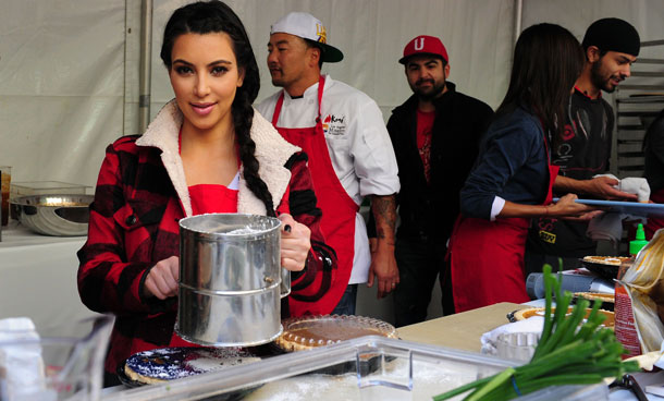Socialite Kim Kardashian pose for photos as celebrities turn out to feed the homeless and those less fortunate a lunchtime meal at the Los Angeles Mission on Nov 23, 2011 in downtown LA in celebration of Thanksgiving. The LA Mission has been helping people on skid row for the past 75 years, providing emergency services like shelter, food, clothing as well as professional medical and dental services. (AFP)