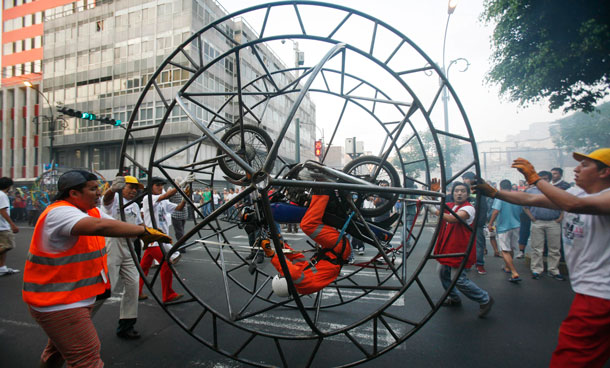 A French street theatre company, Generik Vapeur perform "Lima Rueda", an artistic parade at San Martin's square in downtown Lima, December 4, 2011. The parade seek to promote the use of bicycles in the city. (REUTERS)