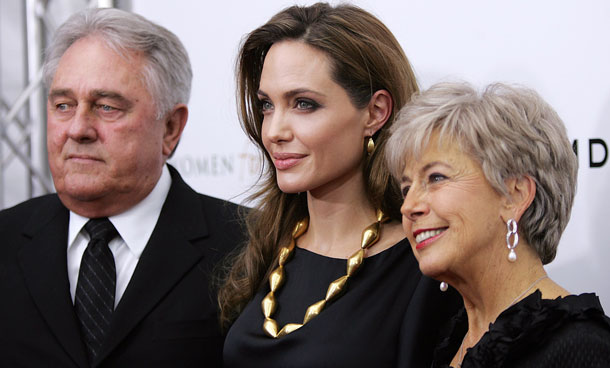 Angelina Jolie (C) poses for photos with her partner Brad Pitt's parents Bill and Jane as they arrive at the screening of her directorial debut "In the Land of Blood and Honey" in New York December 5, 2011. (REUTERS)