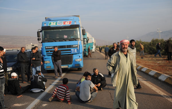 Syrian refugees block a highway on December 5, 2011 during a demonstration near the Turkish border town of Reyhanli in Hatay province after Turkish authorities expulsed two Syrian refugees back to their country following their arrest at the border. Damascus decided on December 1 to suspend the 2004 trade pact after Turkey, one of Syria's closest economic partners, followed in the footsteps of the Arab League in announcing a series of sanctions on the Syrian regime of President Bashar al-Assad for its months-long crackdown on anti-regime protesters that has claimed more than 4,000 lives according to the United Nations. (AFP)