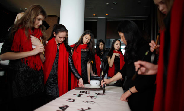 Competitors at the Elite Models Look event, attend a Chinese character writing exhibition during a visit in Shanghai November 29 , 2011. Sixty-five girls from around the world will participate in the 28th Elite Model Look final in Shanghai on December 6, 2011.  (REUTERS)