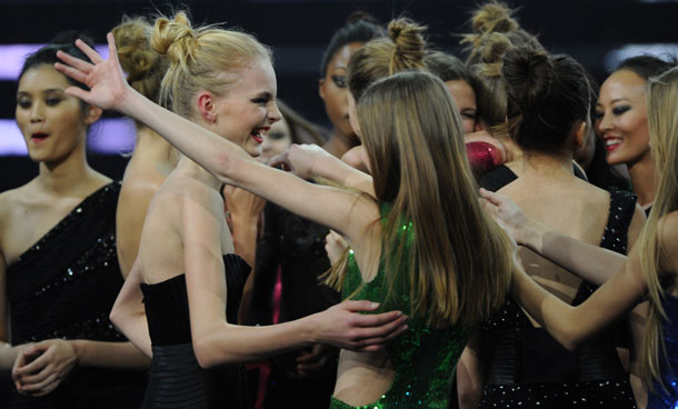 Elite Model Look competition winner Julia Schneider of Sweden (C/L) celebrates with contestants on stage in Shanghai on December 6, 2011. The 28th edition of Elite Model Look World Final took place in China for the fourth year in a row. (AFP)
