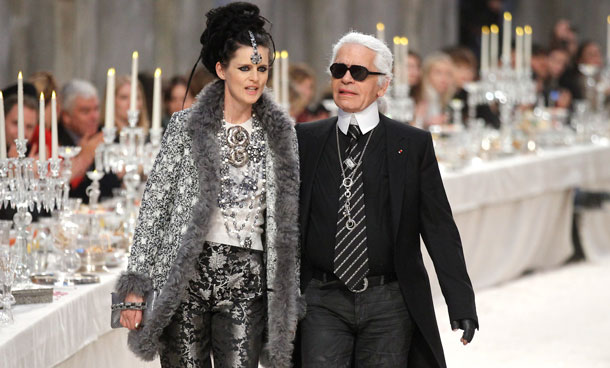 British model Stella Tennant walks with designer Karl Lagerfeld during the Metiers D'Art Show for Chanel fashion house in Paris December 6, 2011. The show, which exists since 2003, is an homage to Chanel workshops. (REUTERS)