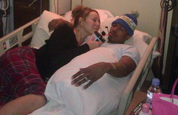Mariah Carey feeds her husband Nick Cannon a drink after he is hospitalised with mild kidney failure. (BANG)