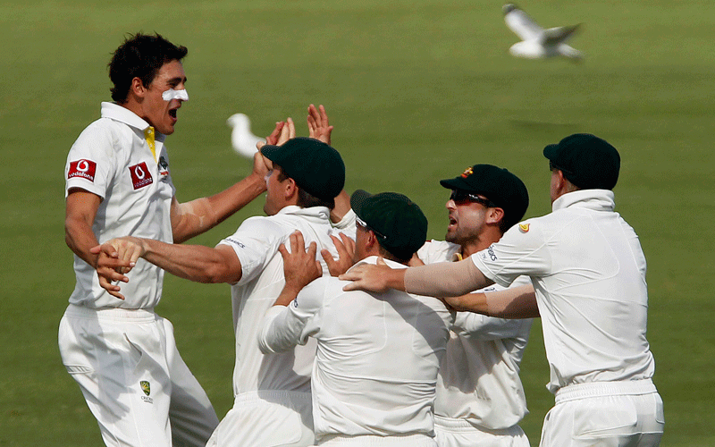 Mitchell Starc (L) of Australia celebrates taking the wicket of Gautam Gambhir of India during the second day of their third test cricket match at the WACA in Perth. (REUTERS)