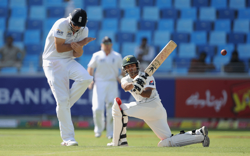 Mohammed Hafeez of Pakistan hits past Alastair Cook of England during the first Test match between Pakistan and England at The Dubai International Cricket Stadium in Dubai, United Arab Emirates. (Getty Images)